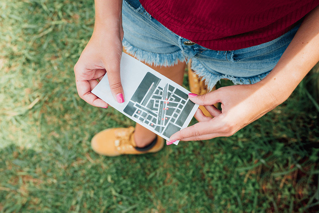 top view woman holding directions card